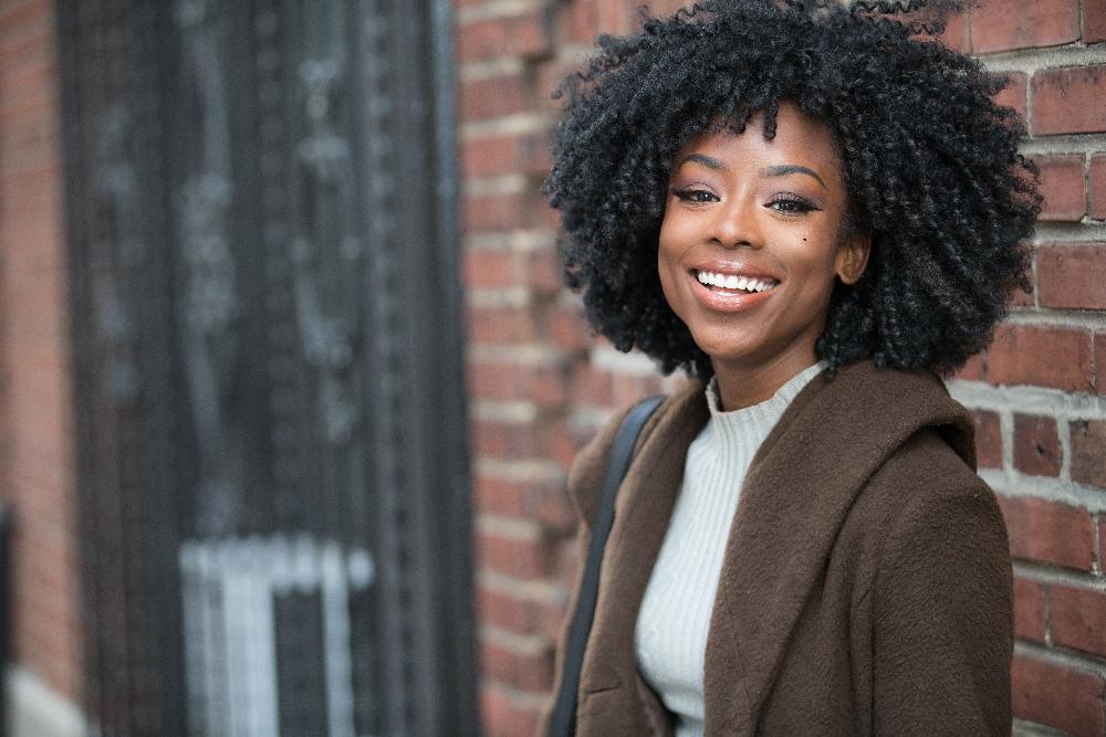 woman in brown jacket smiling | teeth whitening los gatos ca