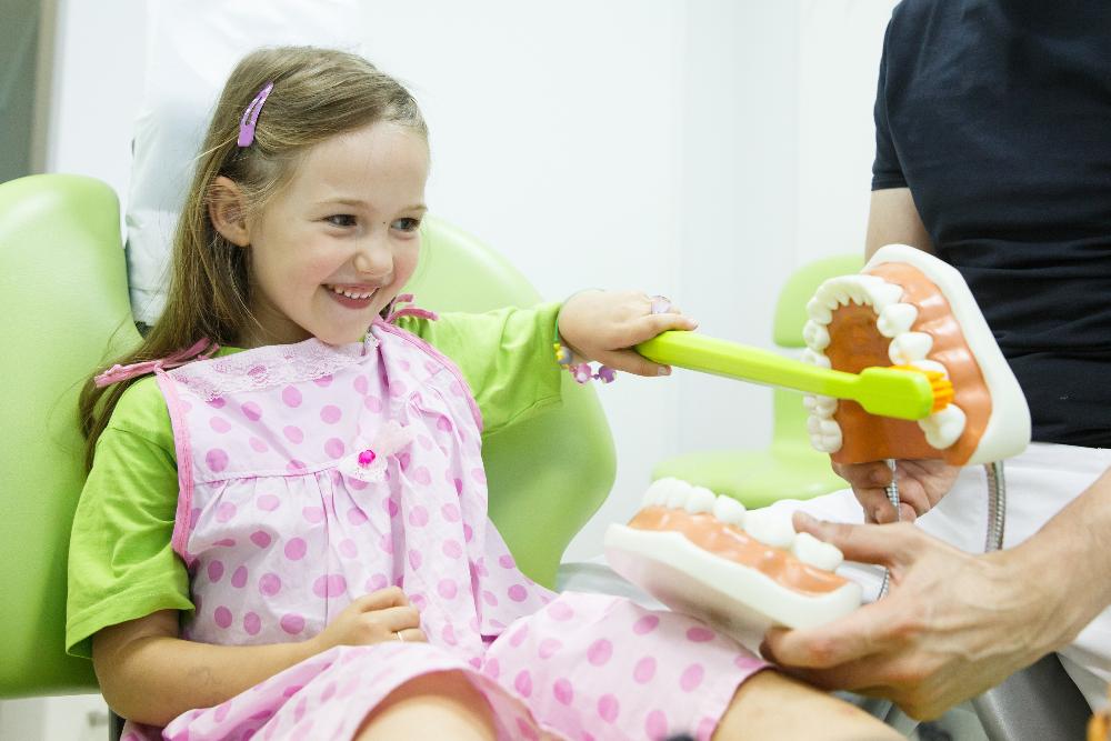 young girl sitting in dentist exam chair | children's dentist los gatos ca