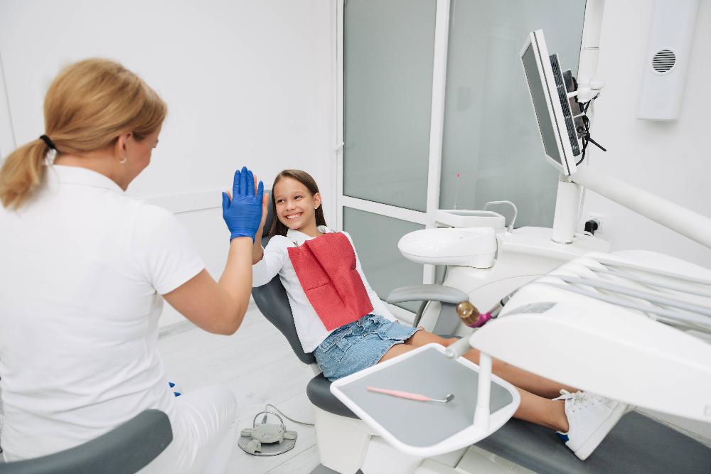 child smiling in exam chair | family dentist los gatos ca
