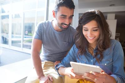 Man and woman smiling and look at tablet, los gatos ca