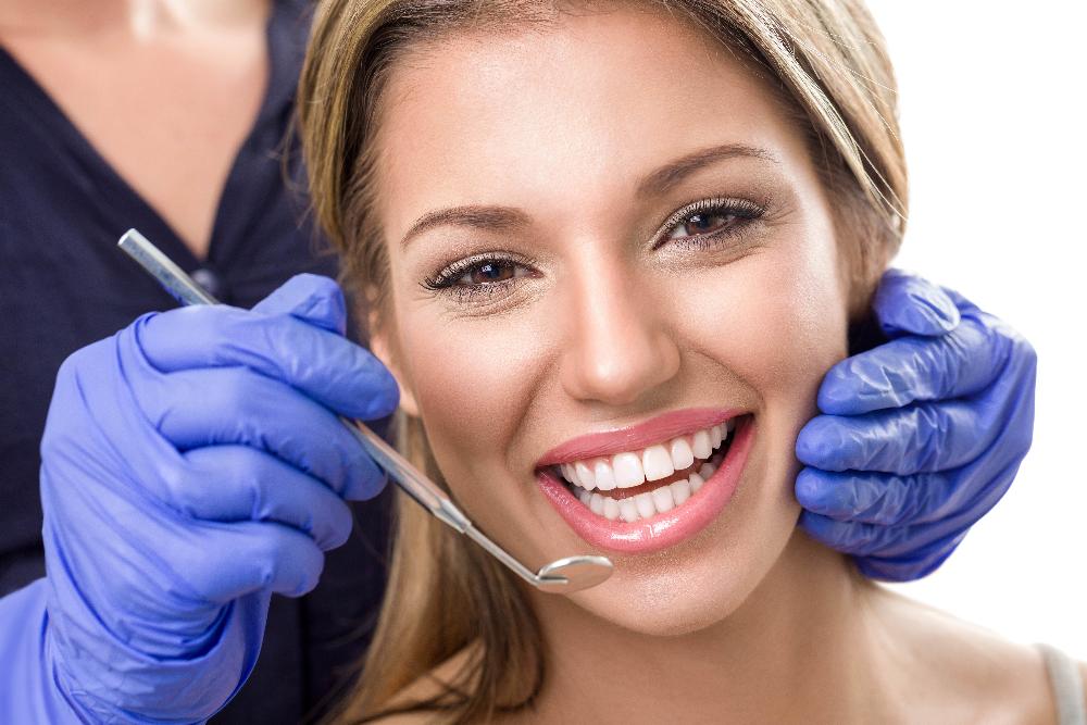 woman with dentist and dental tool | cosmetic dentist los gatos ca