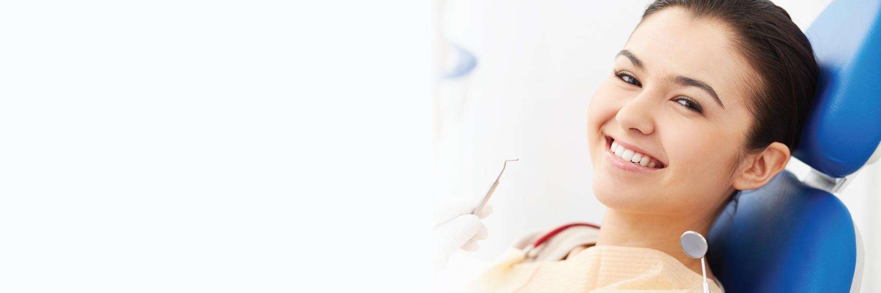 woman sitting in dentist exam chair | dentist office los gatos 