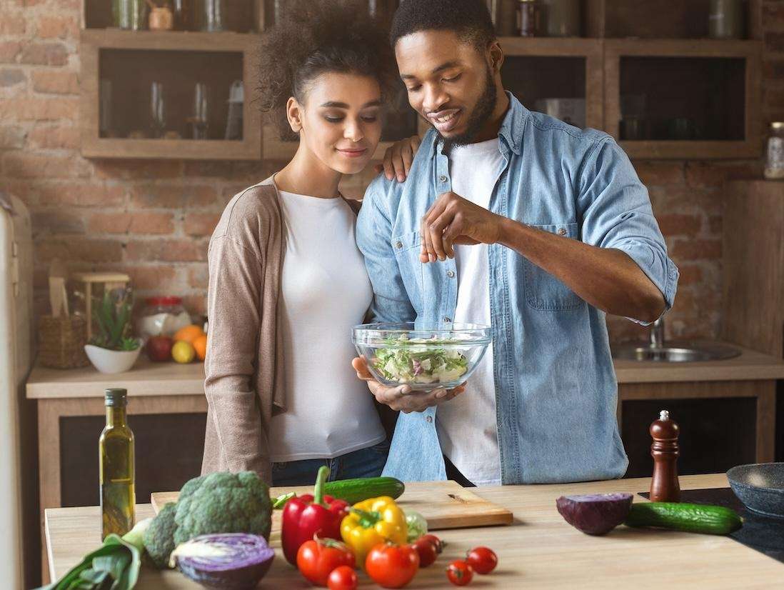 young couple cooking dinner | dentist los gatos ca