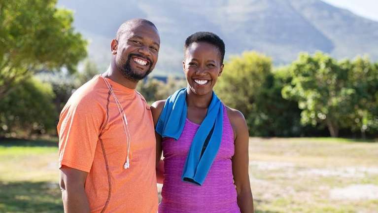 Middle aged black man and woman smiling after dental crows, los gatos ca