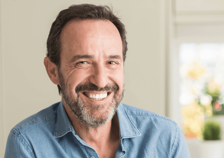 man in collared shirt smiling | dental crowns los gatos ca