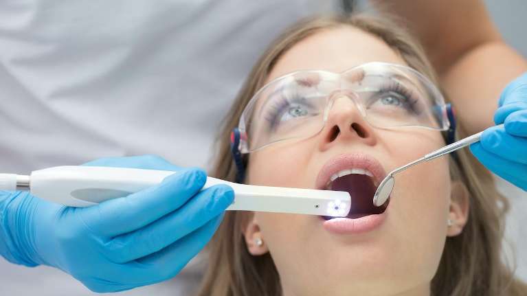 woman receiving dental exam | dental crowns los gatos ca