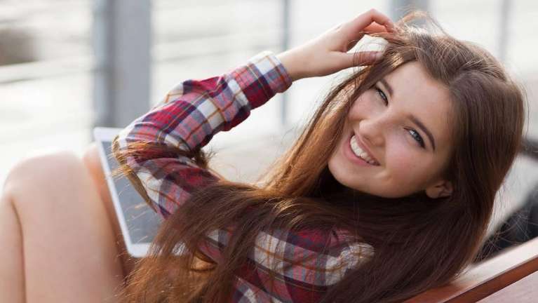 woman with plaid smiling | veneers before and after