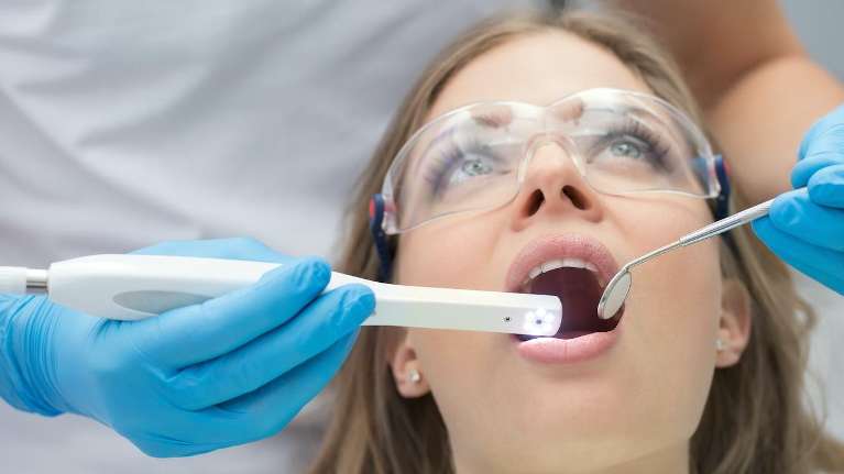 woman receiving dentist exam | white spot treatment los gatos