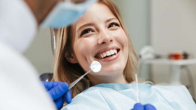 woman smiling at her first dental appointment in Los Gatos