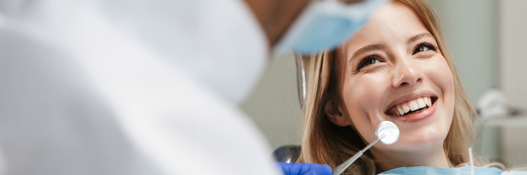 woman smiling with dentist tool | general dentistry in los gatos