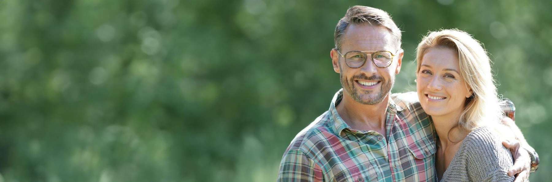 woman and man with glasses hugging outside | dentist los gatos ca