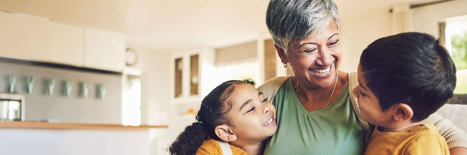 older woman with two children hugging | cosmetic dentist los gatos ca